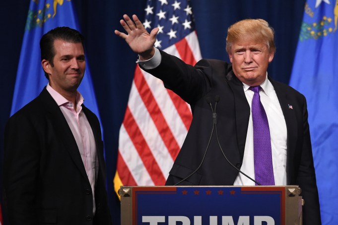 LAS VEGAS, NV - FEBRUARY 23:  Donald Trump Jr. (L) looks on as his father, Republican presidential candidate Donald Trump, waves after speaking at a caucus night watch party at the Treasure Island Hotel & Casino on February 23, 2016 in Las Vegas, Nevada. The New York businessman won his third state victory in a row in the "first in the West" caucuses.  (Photo by Ethan Miller/Getty Images)